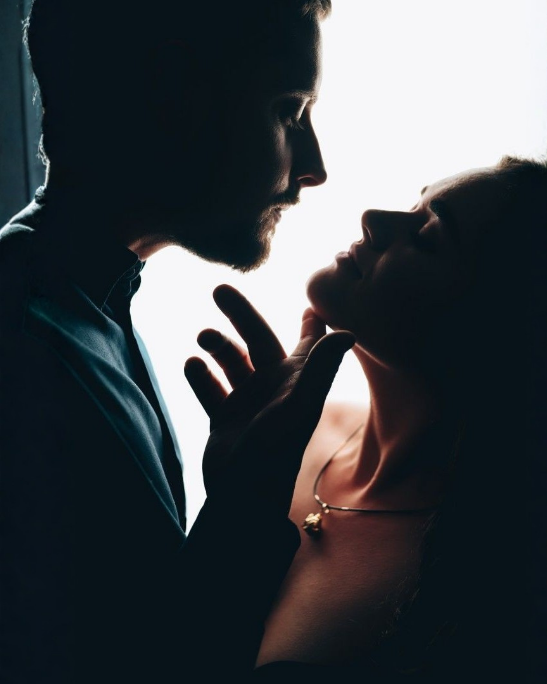 Man photographed from behind with his hand on his neck